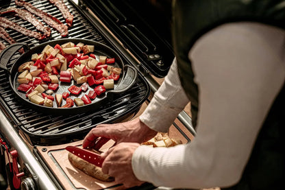 a person cooking food on a grill