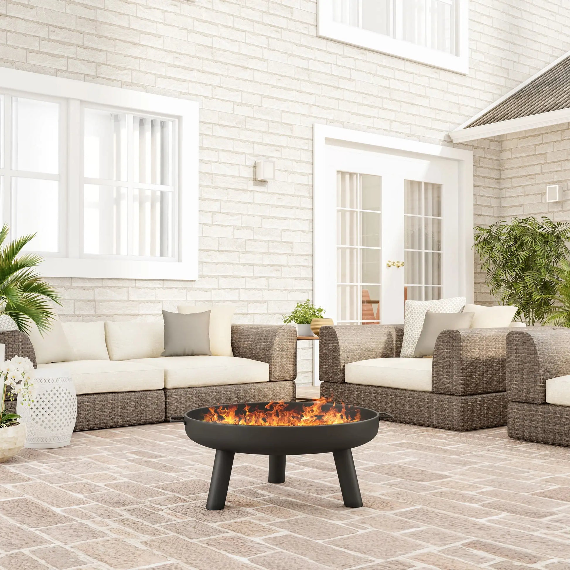 a patio with a fire pit and sofas